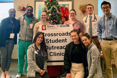 A group of medical students poses for a photo outside an outreach clinic.